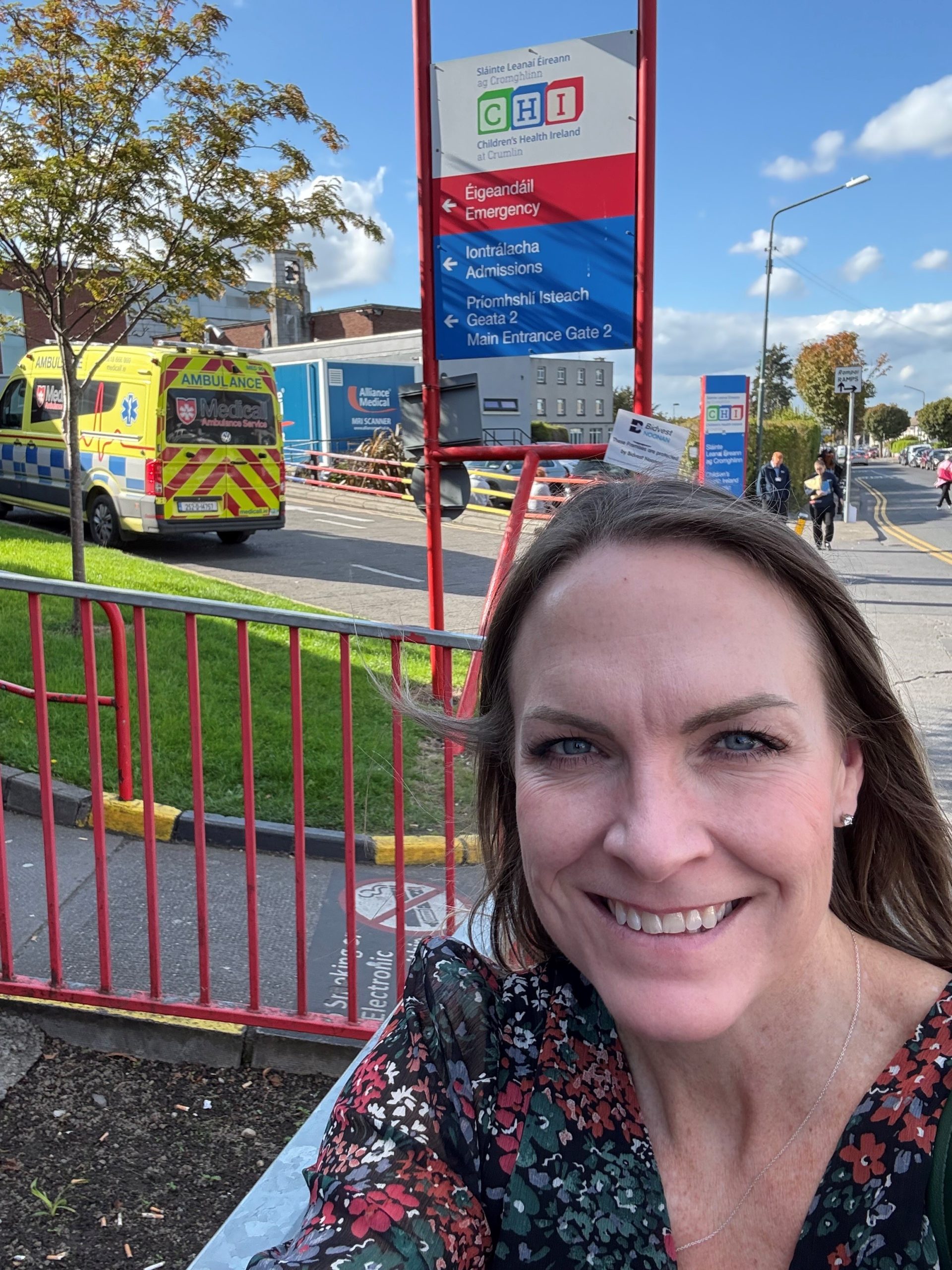CEO Michelle Reynolds in front of signs at CHI Crumlin